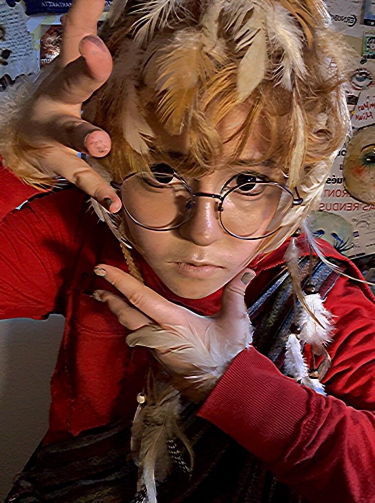 Feathers braided through hair and held against the face